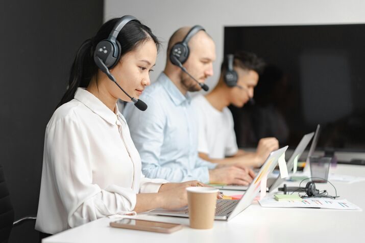 Illustration of a customer service team with headset icons, support tickets, and satisfied customer ratings