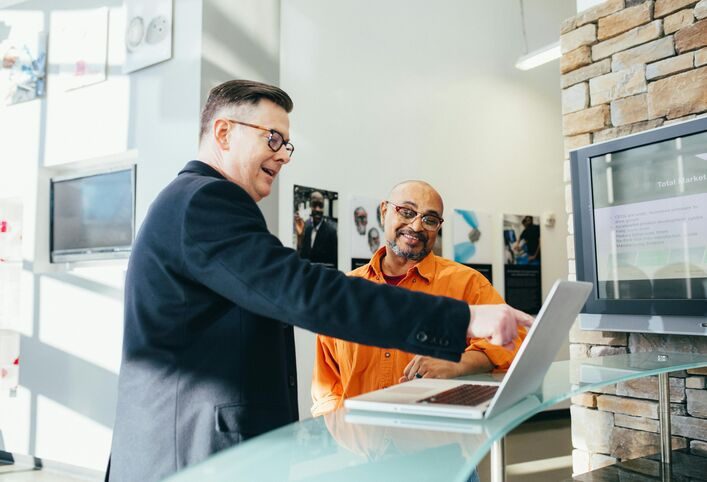 Sales representative using Agentforce dashboard on laptop to track leads and performance metrics.